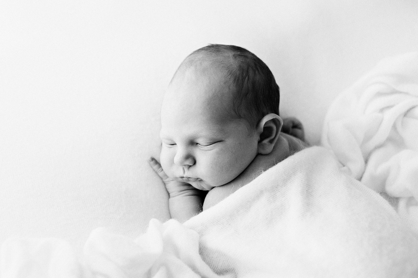 black and white image of a newborn lying on a blanket-newborn-photographer-geelong